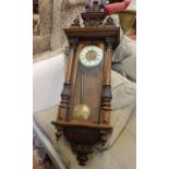 A late Victorian walnut cased Vienna type wall clock with two train movement and two part cresting