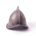 Armour: a coned Morion Pikemans helmet, no lining, domed rivets, peaked rim, 17th century h.25cm