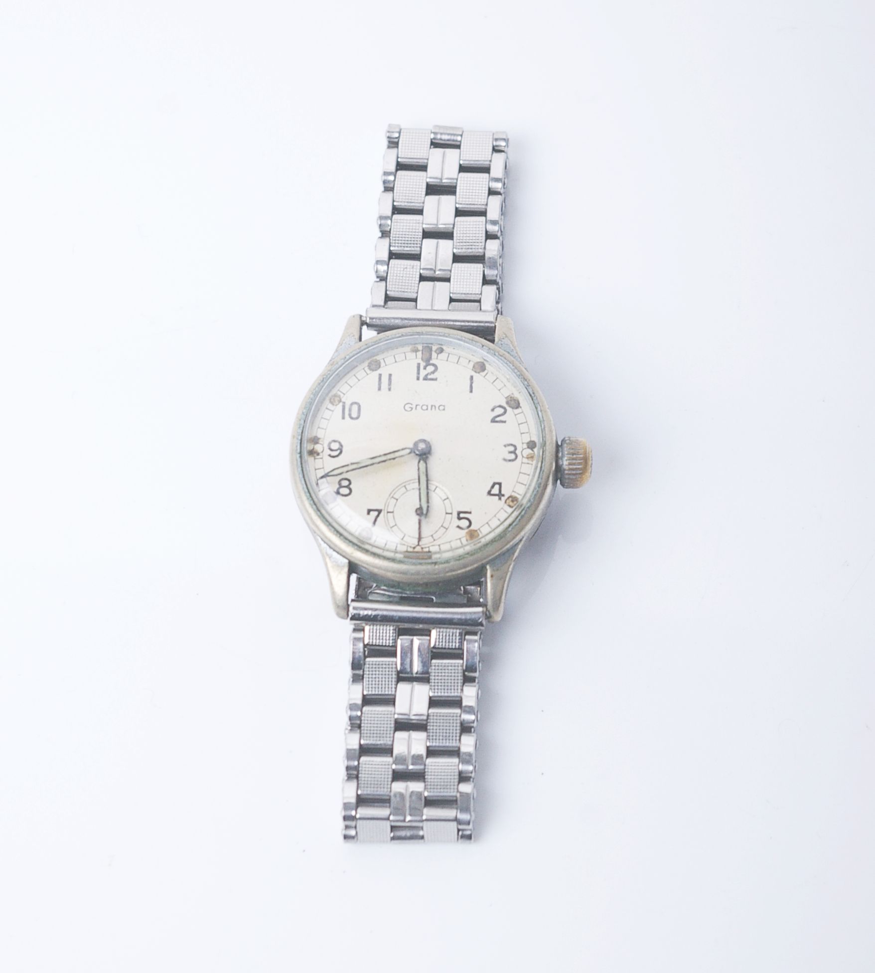 A military nickel-cased round wristwatch, the silvered dial with Arabic and dot indicators and