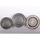 Three pewter chargers, two very similar (42cm) with reeded edging, all marked