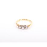 An early 20th century gold and diamond three stone ring, the graduated round brilliants approx. 0.