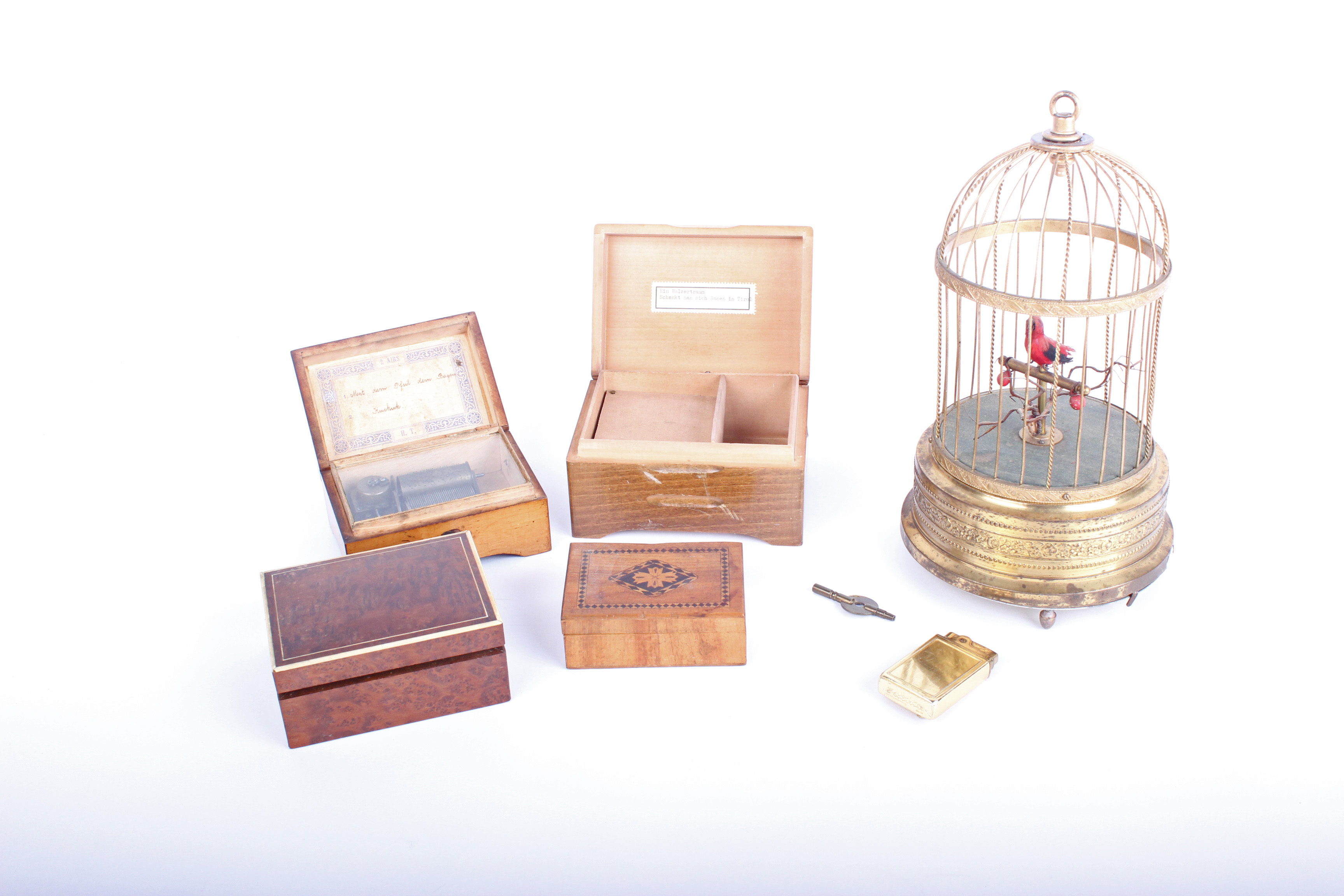 Musical boxes: a bird automation with single bird in a gilt metal cage, mechanism not operational