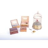 Musical boxes: a bird automation with single bird in a gilt metal cage, mechanism not operational