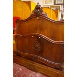 A Louis XV style mahogany double bed frame with carved detail