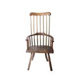 A comb back open armchair with 'D' shaped seat in yew, beech and elm, probably 17th century and once