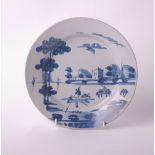 A Delft plate painted in the Chinese manner, a river scape, probably Lambeth, diameter 23cm