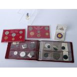 A pocket coin album containing twelve early GB coins, two cased 1967 Decimal sets, a boxed Thai