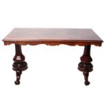 An early Victorian rosewood centre table on well-carved baluster facet supports, with shaped