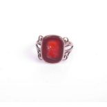 An early 20th century gold and carnelian signet ring, the oblong carnelian with an intaglio bust
