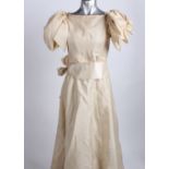 A late 19th Century pale yellow cotton and silk ensemble; a lace shawl, a muslin edged apron and two
