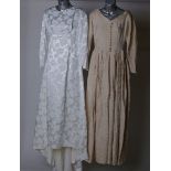 A 1950s cream and ivory brocade full length wedding dress; a 1960s white satin full length wedding