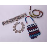 A collection of late 19th Century beadwork items; to include a Zulu collar, four belts, a bag and an