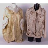 An early 20th Century pale yellow evening coat edged with Swansdown; an early 20th Century cream