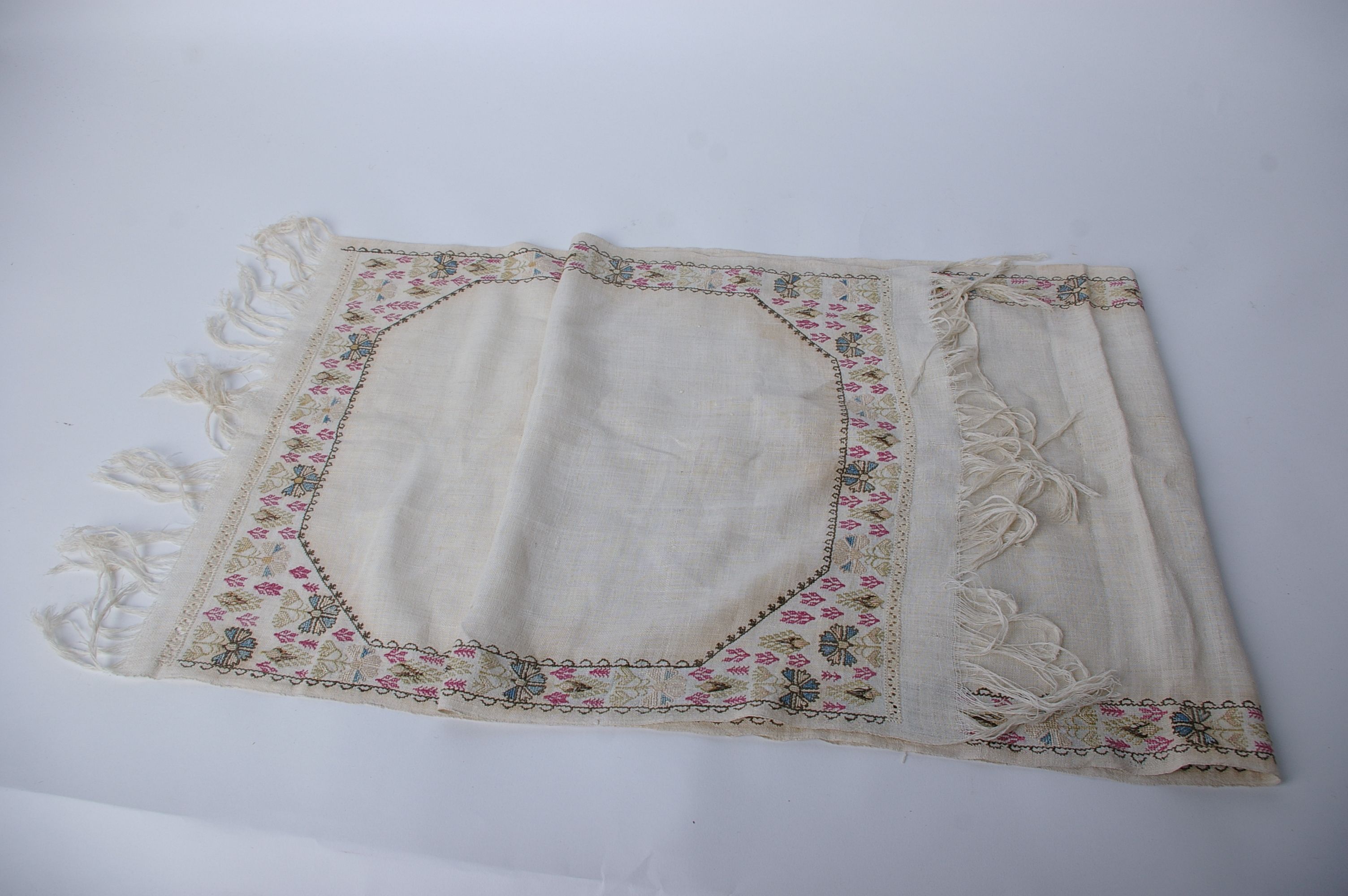 A 19th Century late Ottoman fine linen fringed towel, with a reversible embroidered floral design