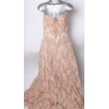 An early 20th Century ivory satin dress in need of restoration; An American pink lace prom-style