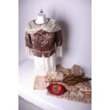 A late 19th Century brown silk parasol; an early 20th Century black fringed embroidered shawl, a