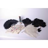 A collection of ostrich and other feathers suitable for millinery use. Four ostrich feather fans,