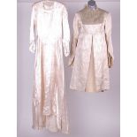 A 1930s cream satin wedding dress with a pale coloured loosely sketched design of flowers covering