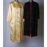 An early 20th Century black silk Chinese robe with a vibrant fuchsia pink lining; a mid 20th Century