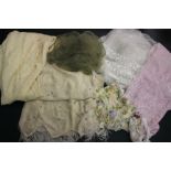 A quantity of garments for repair/restoration; to include a pale pink satin and cream lace