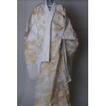 A modern ceremonial Japanese kimono. Decorated with a design of white flowers, yellow leaves edged