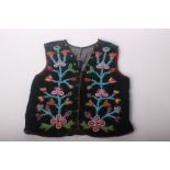 A 19th Century North American Indian Ojibway (Ojibwa) beaded vest or waistcoat, decorated with a