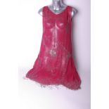 A 1920s dark pink flapper dress with silver bead decoration and fringing; a 1930s black lace dress