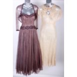 A 1930s coffee lace gown and jacket, trimmed with brown silk velvet; a pale nude coloured 1930s