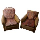 A pair of early 20th century leather club chairs with kelim style cushions
