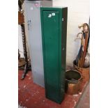 A steel gun cabinet, green finish, baize lined, 126cm high, 25cm wide, no key but unlocked