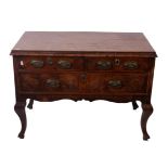 A 18th Century and later walnut and oak chest with two short and one long drawer on shaped legs 69cm