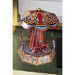 A tin plate toy of a carousel and other toys. Modern as new