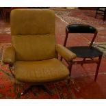 An ESA low swivel armchair with chrome supports and a teak dining chair. Not suitable for domestic