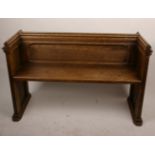 An oak pew, with moulded end supports 127cm length