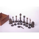 An Indian ornate half chess set in horn, well carved, king piece 10cm high. In mahogany box