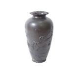 A Japanese bronze vase with a flared top and decorated with embossed hunting scene 55cm high