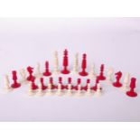 Two chess sets: a bone chess set of barleycorn type, red and white, king piece 9cm high, complete,