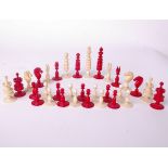 An ivory chess set barleycorn type, red and white, king piece 10cm high, complete, early 20th