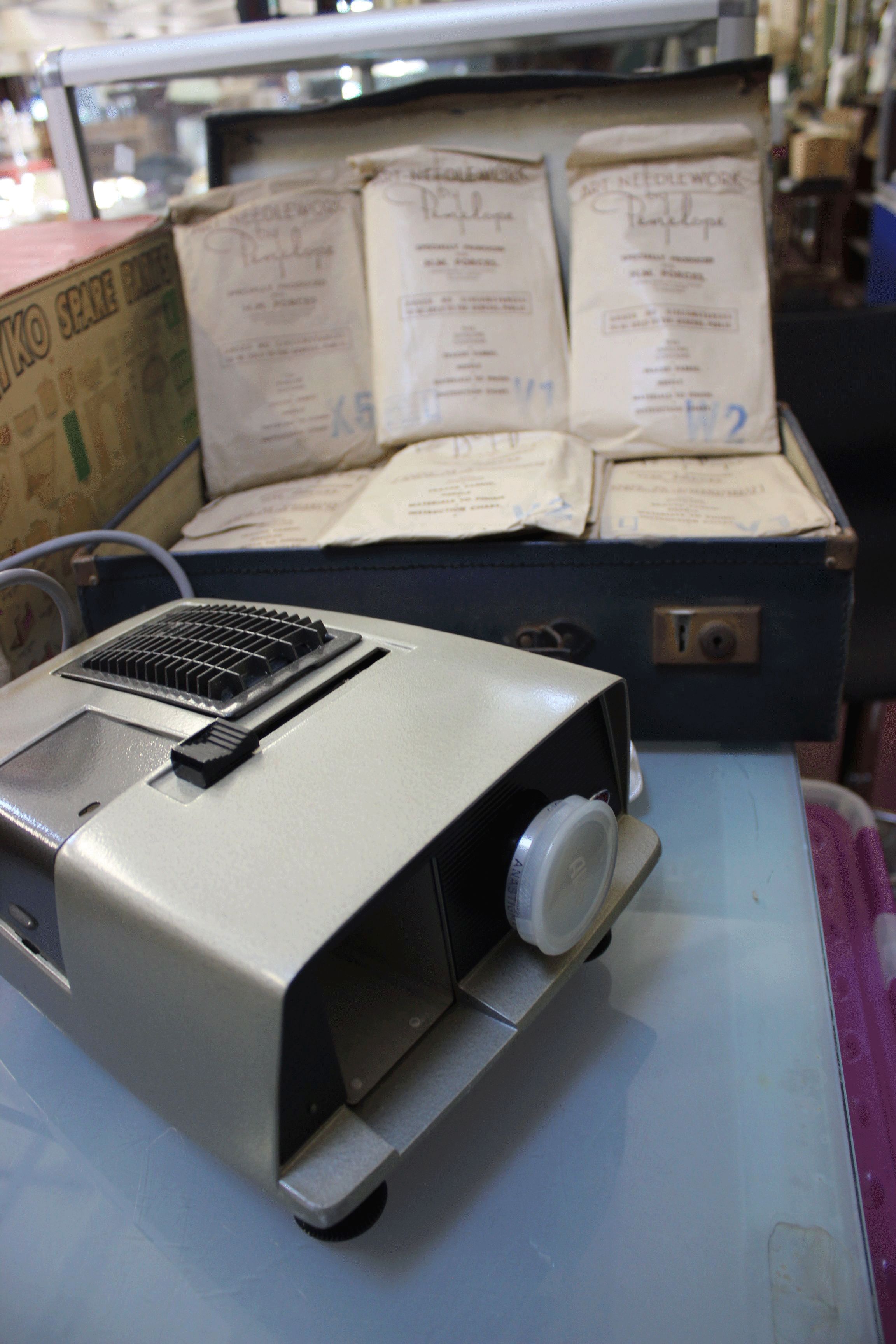 A suitcase containing a collection of 'Art Needlework' kits by Penelope specifically produced for HM