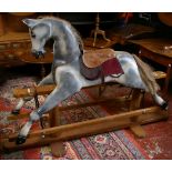 A Victorian style rocking horse on swing stand, dapple grey in wood and composition on wooden