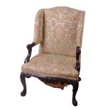 A Georgian Irish style carved mahogany and open wing armchair