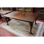 An early 20th century mahogany dining table on cariole legs 176cm length