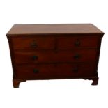 A George III mahogany chest with two short and two long drawers, flanked by brass capped quarter