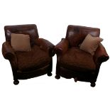 A pair of early 20th Century leather tub chairs