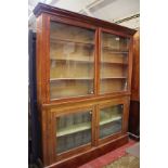 A 19th Century two part mahogany glazed bookcase, top and base associated enclosing shelves 212cm