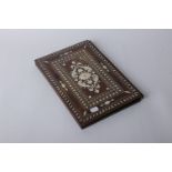 An Anglo-Indian ivory mounted wooden book cover, rectangular form, with central pierced medallion