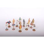 A collection of twenty four painted plaster figurines: Indian costume based on terracotta 19th