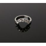 A diamond five stone 'arched' ring, designed to fit around another ring, the round brilliants,