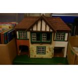 An early 20th Century Lines painted dolls house , with furnishings