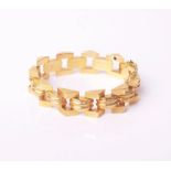 A vintage Egyptian gold bracelet in the form of reeded arches with triangular borders, approx 17cm